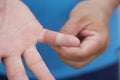 Close up man uses adhesive bandage tape to cover wound on finger. Royalty Free Stock Photo