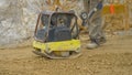 CLOSE UP Man uses manual levelling machine to prepare ground for mortar pouring