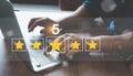 Close up man using Lap top for rating feedback from customer service with annual survey with five gold star icon. Business annual
