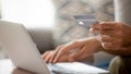 Close up man using laptop, shopping online, pay by credit card Royalty Free Stock Photo