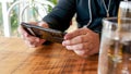 Close up of a man using mobile smart phone at the restaurant while drinking beer Royalty Free Stock Photo