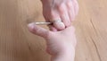 Close up of a man using a nail scissors to cut his nails. Personal care concept