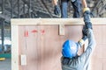 Close up of a man using a pneumatic nail gun to finish the trim wooden box