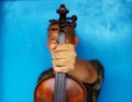 A close up of a man with a violin  Old wooden dark brown choose the focus background blurred blue Royalty Free Stock Photo