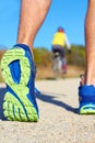 Close up of man walking in nature with biker in background Royalty Free Stock Photo