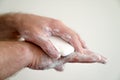 Close up of man washing his hands with a bar of soap and soapy suds Royalty Free Stock Photo