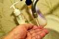 Close-up of a man washing his hands under running tap water Royalty Free Stock Photo