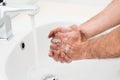 Close up of man washing very dirty hands with soap under faucet running water. Royalty Free Stock Photo