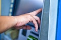 Close-up of man wearing blue jean, using credit card to withdrawing money from ATM machine. Finance and business concept Royalty Free Stock Photo