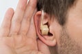 Close-up Of Man Wearing Hearing Aid In Ear Royalty Free Stock Photo