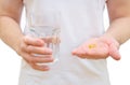 Man holding fish oil pill and glass of water Royalty Free Stock Photo