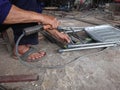 close up, man welding broken chair at his workshop