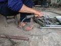 close up, man welding broken chair at his workshop