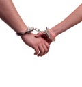 Close up of man and woman holding hands in handcuffs - relationship concept Royalty Free Stock Photo