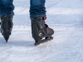 Close up with a man or a woman with skates on ice. Ice skating recreational activity