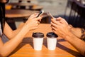 Close up of man and woman typing sms and drinking coffee Royalty Free Stock Photo