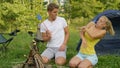 CLOSE UP: Man and woman wave their arms as they get swarmed by pesky mosquitoes.