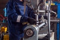 Close-up of a man works with a mettalic hammer