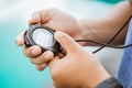 close up of a man& x27;s hand holding and setting a stopwatch