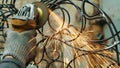 Close-up of a man's hand working with a circular saw. Sparks fly from the hot metal. The man was working hard on the Royalty Free Stock Photo