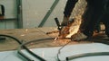 Close-up of a man's hand working with a circular saw. Sparks fly from the hot metal. The man was working hard on the Royalty Free Stock Photo