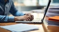 Close-up of a man& x27;s hands typing on a laptop keyboard, with a stack of paperwork beside them. AI generated Royalty Free Stock Photo