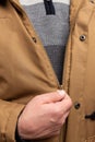 Close-up of man zipping winter jacket