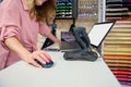 Close-up manager in stationery store holding hand on computer mouse while ordering stationery in office supply store Royalty Free Stock Photo