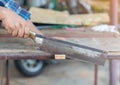 Close up the mand use hand saw cutting wood stick Royalty Free Stock Photo