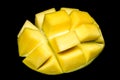 Macro of mango isolated on the black backround. Cubed cut mango. Professional studio photo