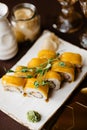 Close-up, mango sushi set on white clay plate