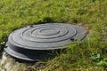 Manhole plastic cover in the garden lawn