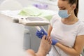 Close-up of manicurist removing cuticle from the nails of feet Royalty Free Stock Photo