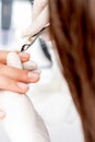 Close up of manicurist using manicure clipper