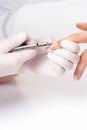 Close up of manicurist using manicure cutter