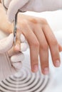 Close up of manicurist using manicure scissors