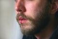 A close up of a mans face with a piercing