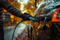 A close-up of a mans hand as he pumps gas into his car at a gas station Royalty Free Stock Photo