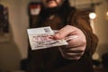 Close-up on a mans hand holding Czech koruna