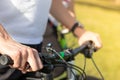 Close up of a mans hand holding onto the bicycle steering wheel, holding the brake pressed. Both hands seen, prepairing to start