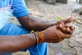 Close up of a mans hand preparing Chewing tobacco.