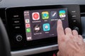 Close up mans hand select the application of navigation or maps on the car dashboard. January 2021, Prague, Czech