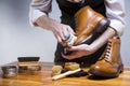 Close Up of Mans Hands Cleaning Luxury Calf Leather Brogues with Special Accessories, Shoe Wax and Tools Royalty Free Stock Photo