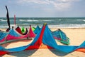 Close-up many bright kitesurf wings and kite equipment sand beach shore watersport spot on bright sunny day against sea