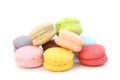 Close up many colorful fresh macarons pile isolated on white background