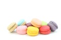 Close up many colorful fresh macarons pile isolated on white background, look delicious