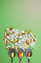 Close up of many different pills on green background Royalty Free Stock Photo