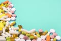 Close up of many different pills on green background Royalty Free Stock Photo