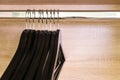 Close-up many empty black clothing racks hanging on coathanger