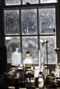 Close up of many glass bottles and measuring devices in the wondow of an old assay office Royalty Free Stock Photo